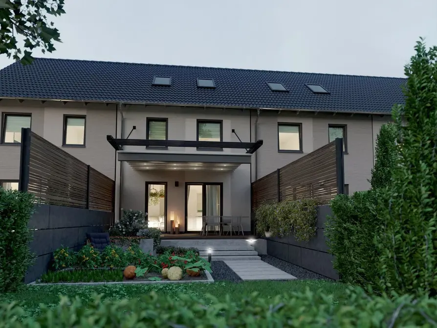 Modernes Reihenhaus Mainz 128 als Massivbau mit vier Wohneinheiten Massiv gebautes Reihenhaus Mainz 128 mit vier Wohneinheiten Gartenansicht in Abendstimmung